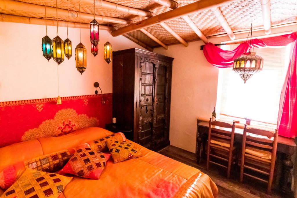 a bedroom with two beds and a window and lights at Little India Vijlen appartement 1 in Vijlen