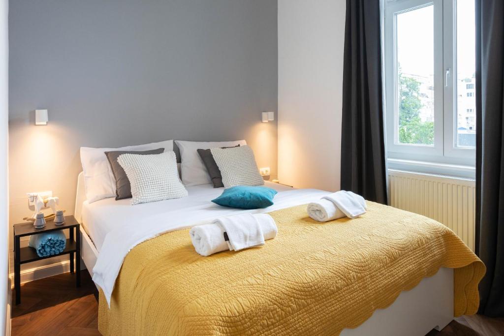 a bedroom with a bed with towels on it at Modern and Design Apartment near the Main Square in Zagreb