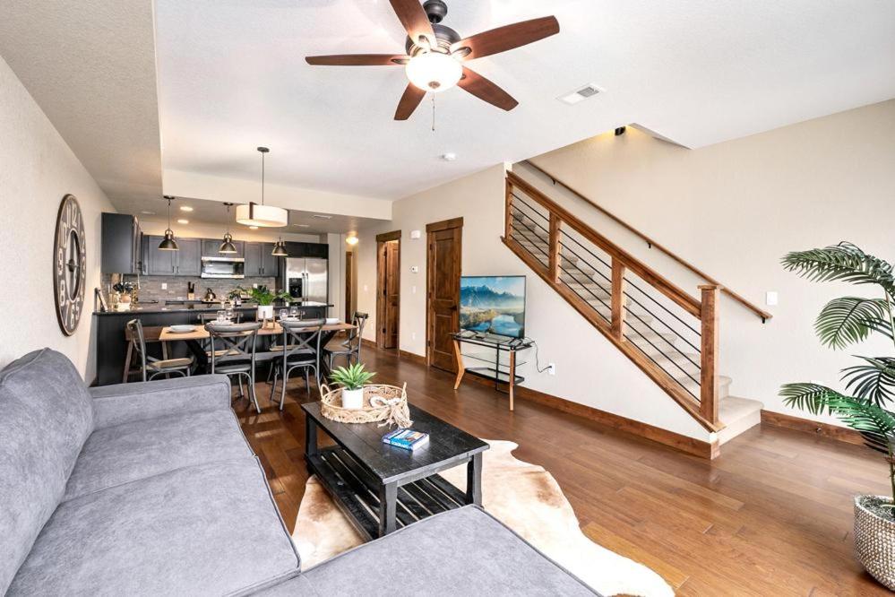a living room with a couch and a ceiling fan at Spectacular Home near Breweries & River District! in Fort Collins
