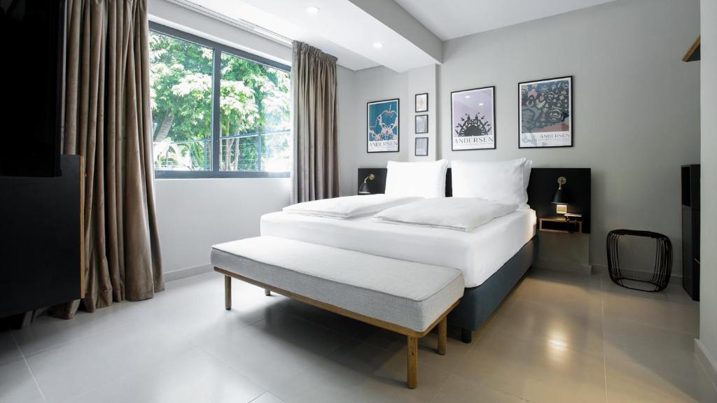 a bedroom with two white beds and a window at Nordic Hotel Lagos in Lagos