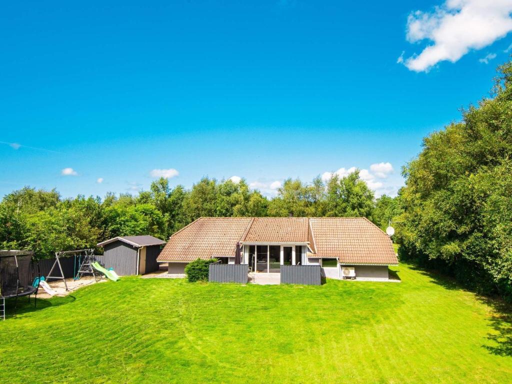 ein Haus mit großem Rasen davor in der Unterkunft 8 person holiday home in Oksb l in Øster Vrøgum