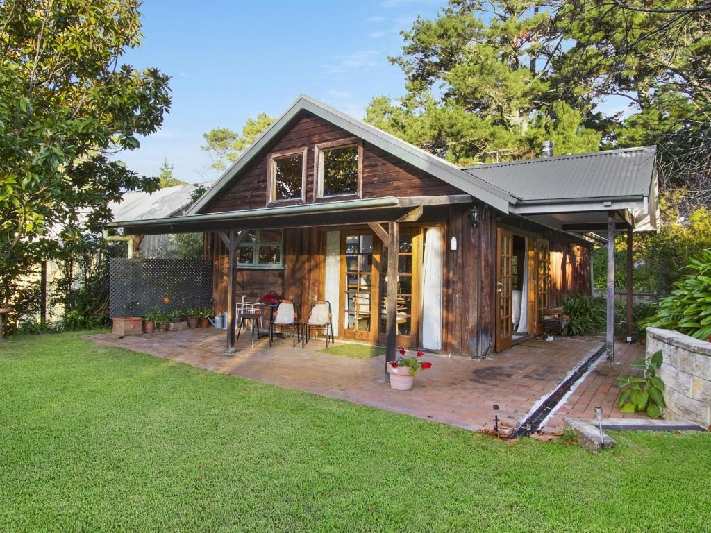 a house with a porch and a patio at Browns Cottage in Bilpin