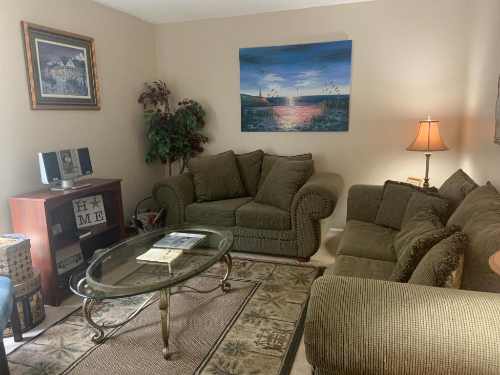 a living room with a couch and a table at Cozy comfortable & convenient in Pensacola