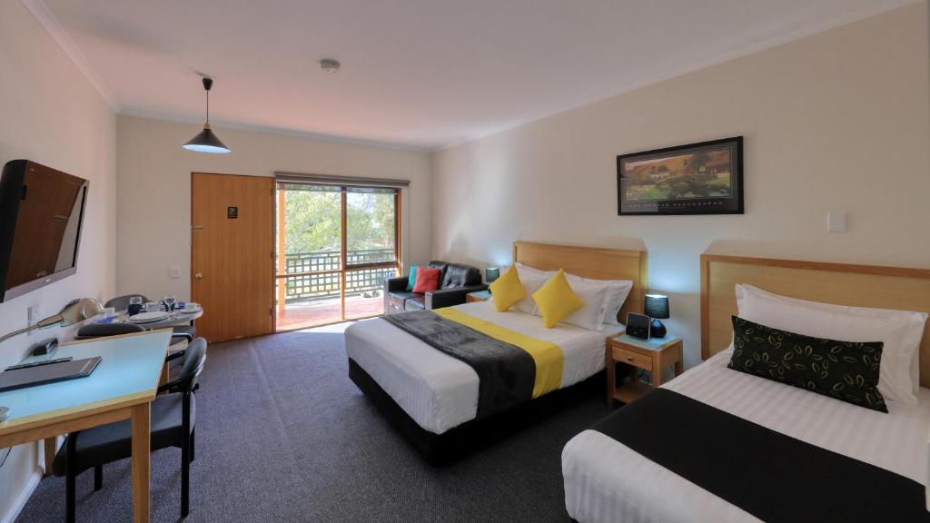 a hotel room with two beds and a desk at Comfort Inn Lady Augusta in Swan Hill