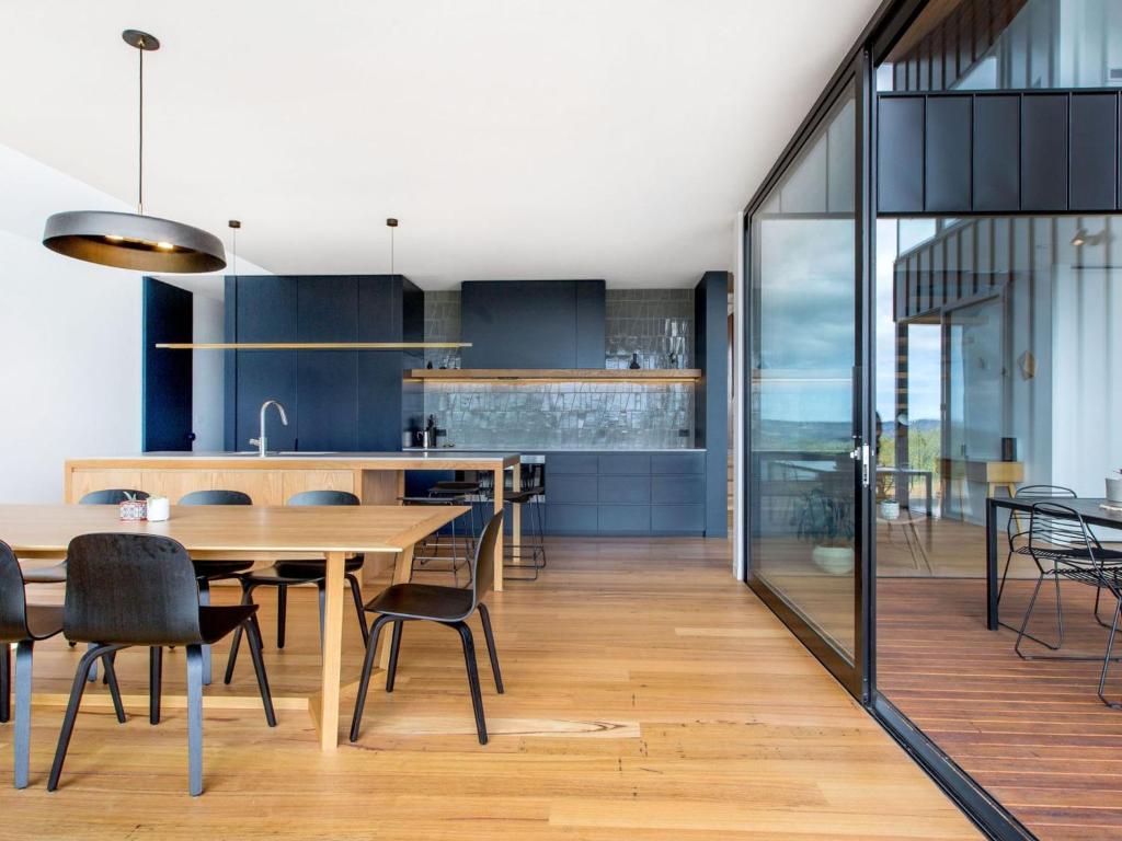 a kitchen and dining room with a table and chairs at COASTAL LUXE MT MARTHA in Mount Martha