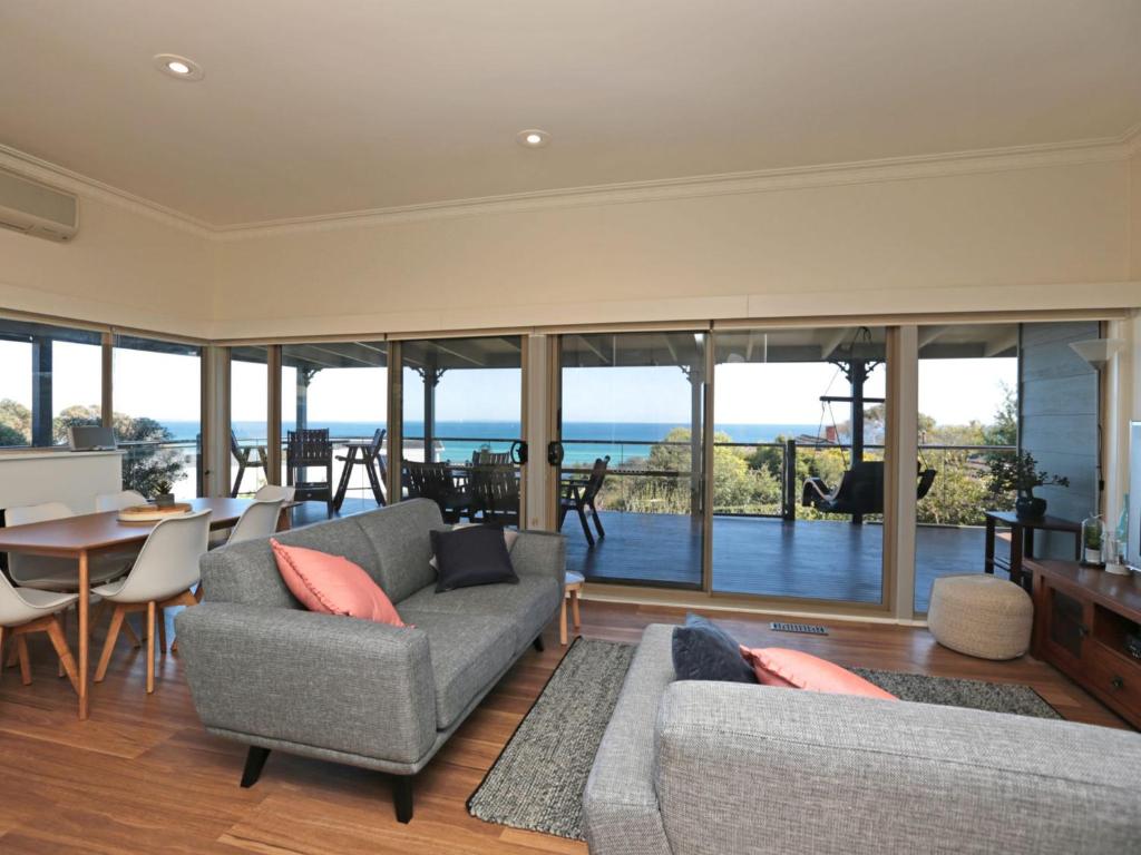 a living room with a couch and a table at Bay Views On Browne in Dromana
