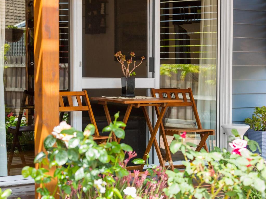 a table and two chairs on a porch at Karinya Mornington in Mornington
