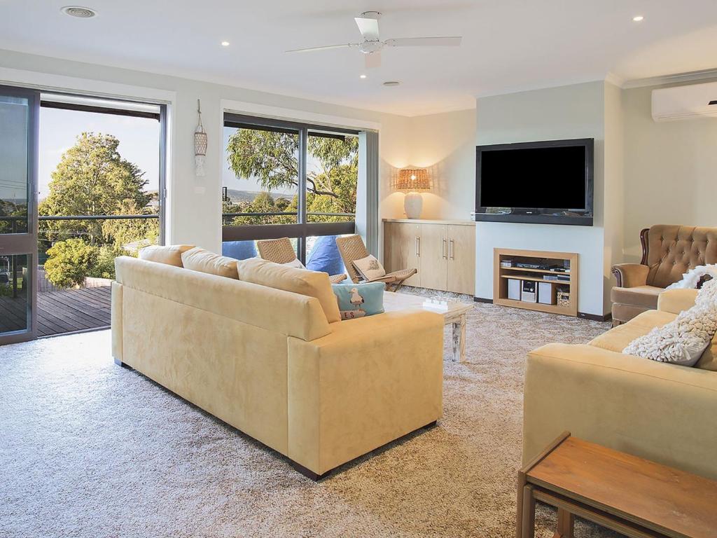 a living room with two couches and a television at Roanjoka Dromana in Dromana