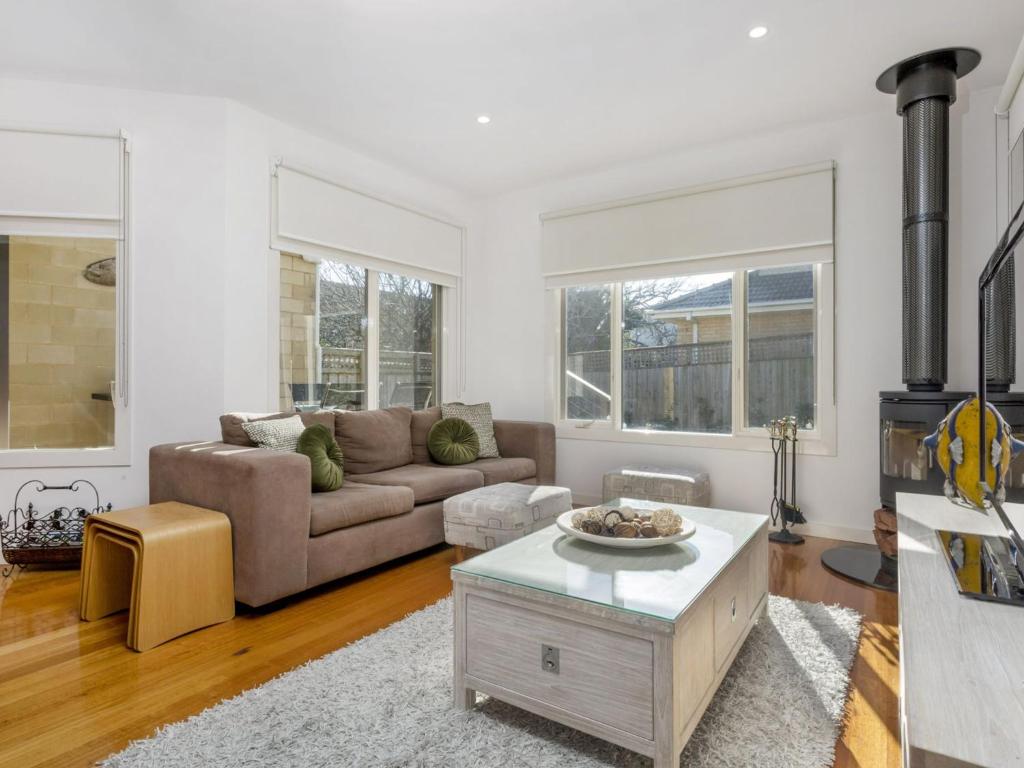 a living room with a couch and a coffee table at Sunset Views Mornington in Mornington