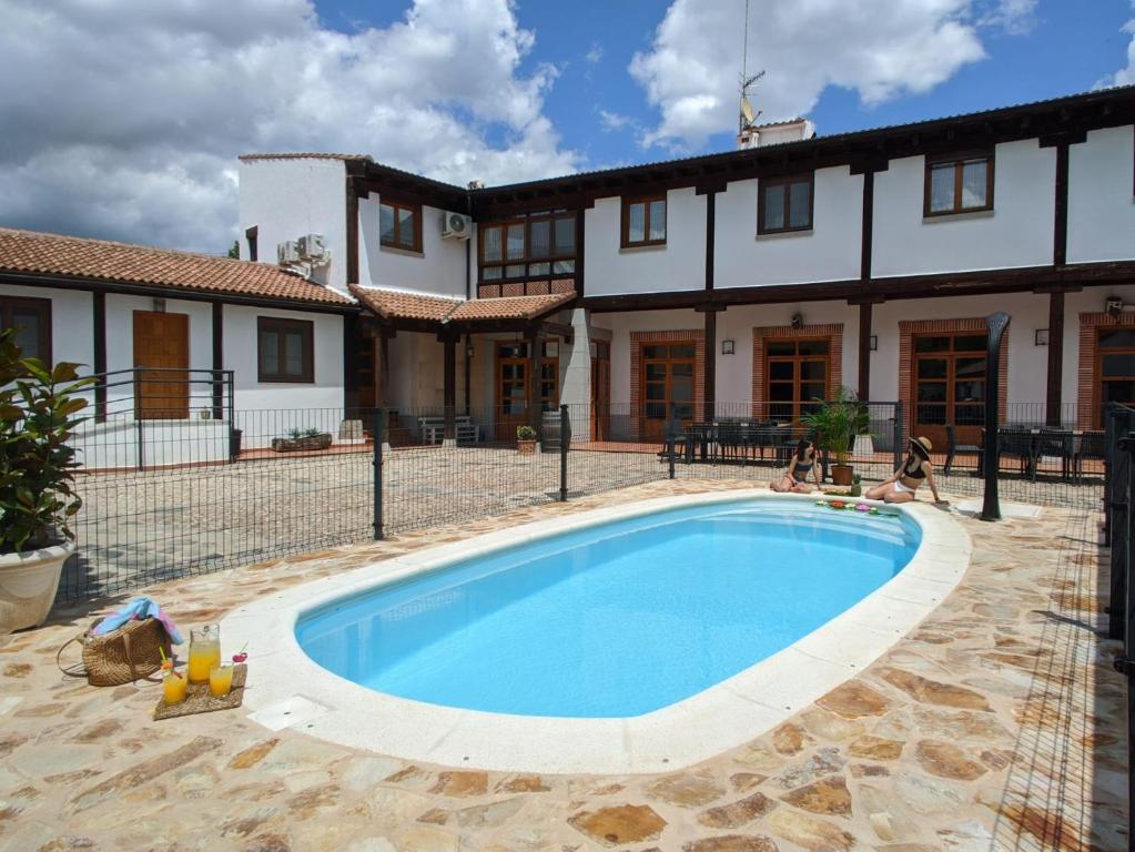 a swimming pool in front of a house at La Casona de los Cinco Caños in Coca