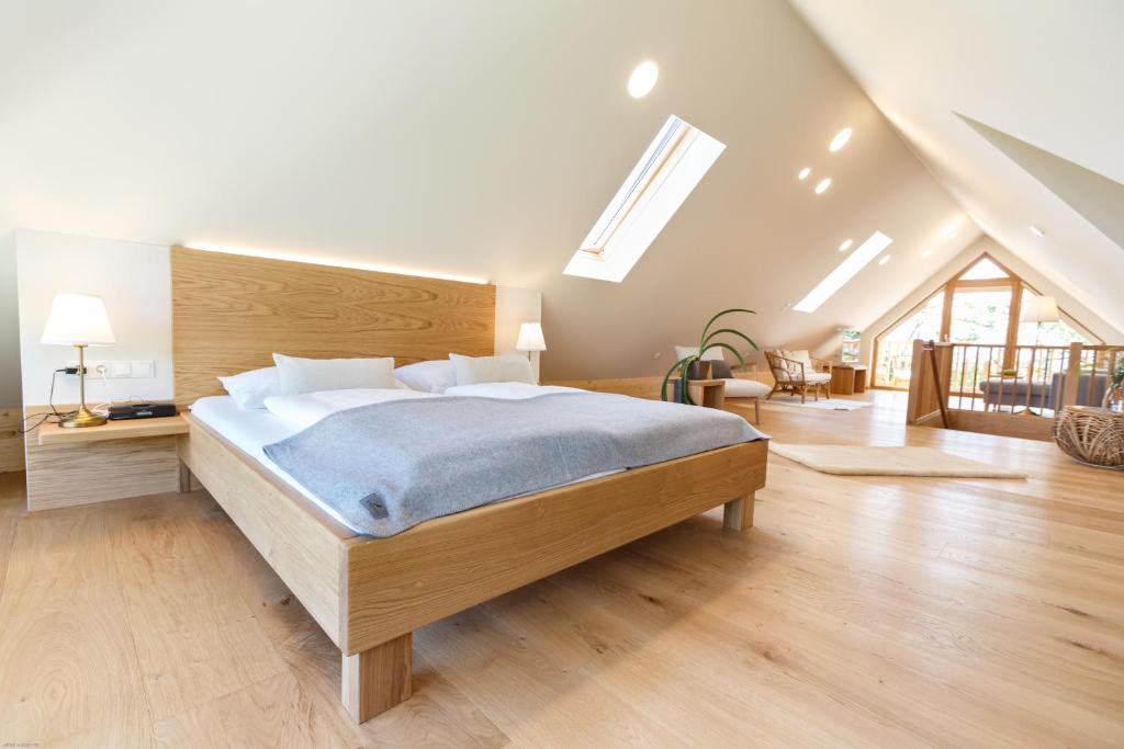 a bedroom with a large bed in a attic at Weingut ADAM Amandus und Carmen in Leutschach