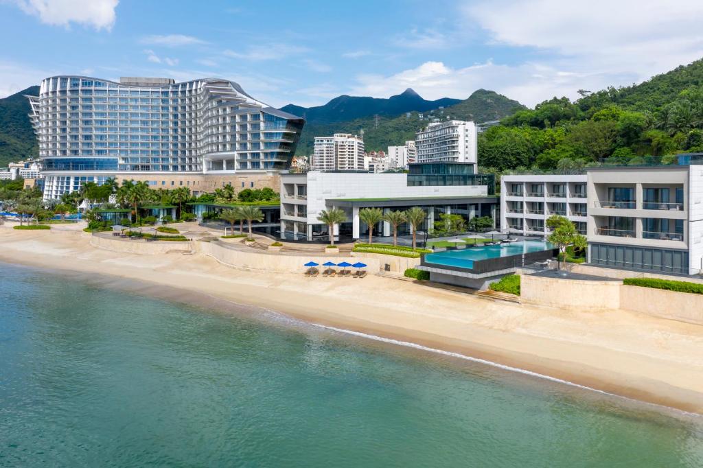 a beach with a lot of palm trees at Intercontinental Shenzhen Dameisha Resort, an IHG Hotel in Shenzhen