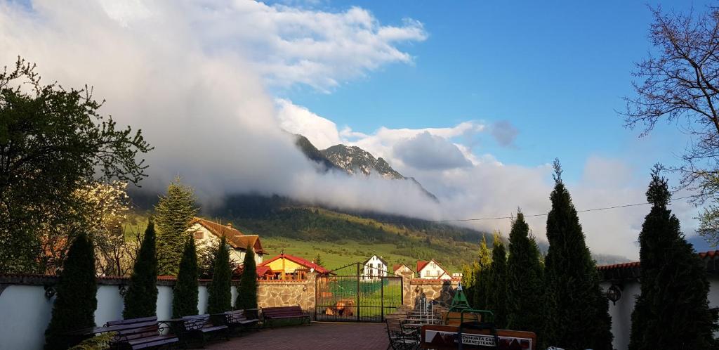a view of a mountain with clouds in the sky at Pensiunea Casa Zarnesteana in Zărneşti