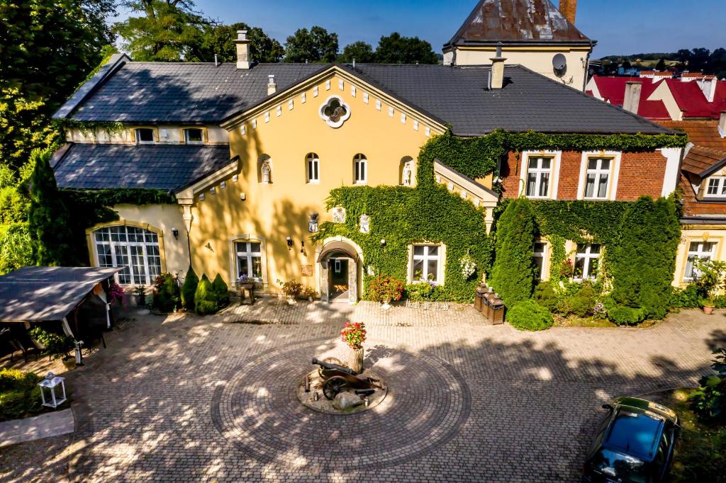 an aerial view of a large house with ivy at Dwór Boratyn in Boratyń