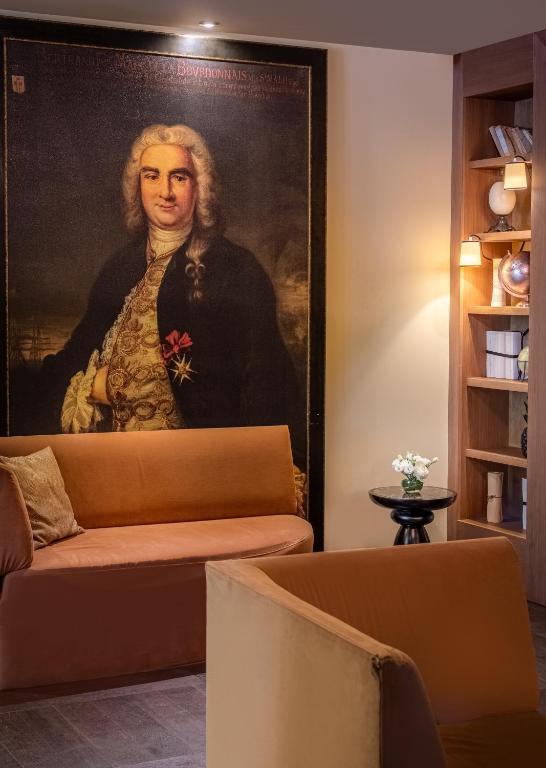 a portrait of a woman in a painting on a wall at Hôtel La Bourdonnais by Inwood Hotels in Paris