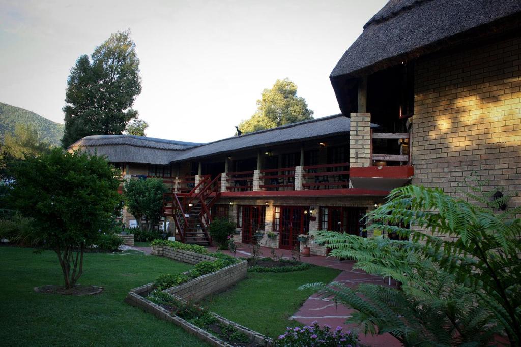 a large building with a staircase in front of it at Storms River Guest Lodge in Stormsrivier