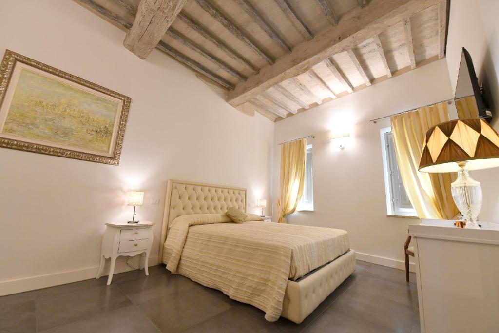 Postel nebo postele na pokoji v ubytování Palazzo degli Stemmi