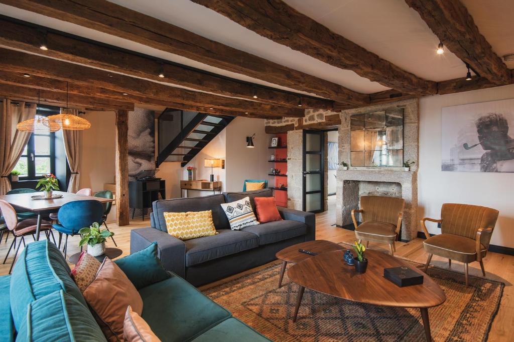 a living room with a couch and a table at Cosy family nest in the medieval town in Dinan