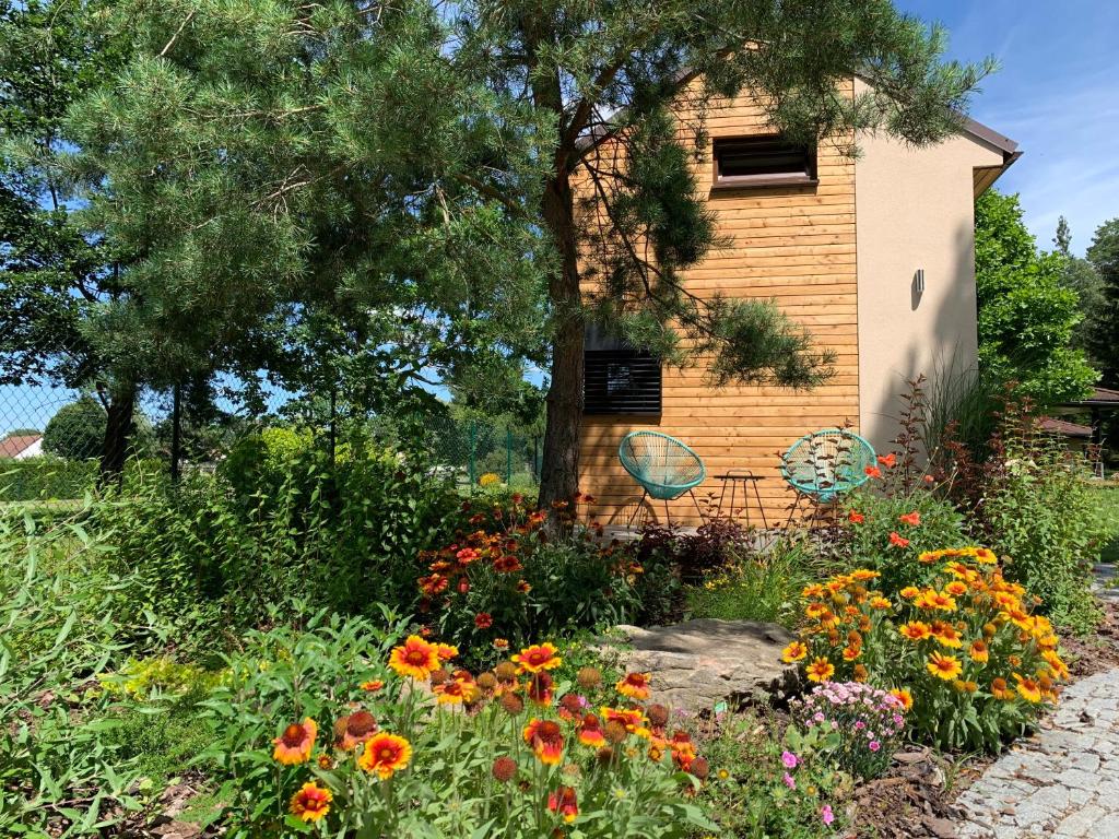 a garden with flowers in front of a house at Tiny Vacation in Písek