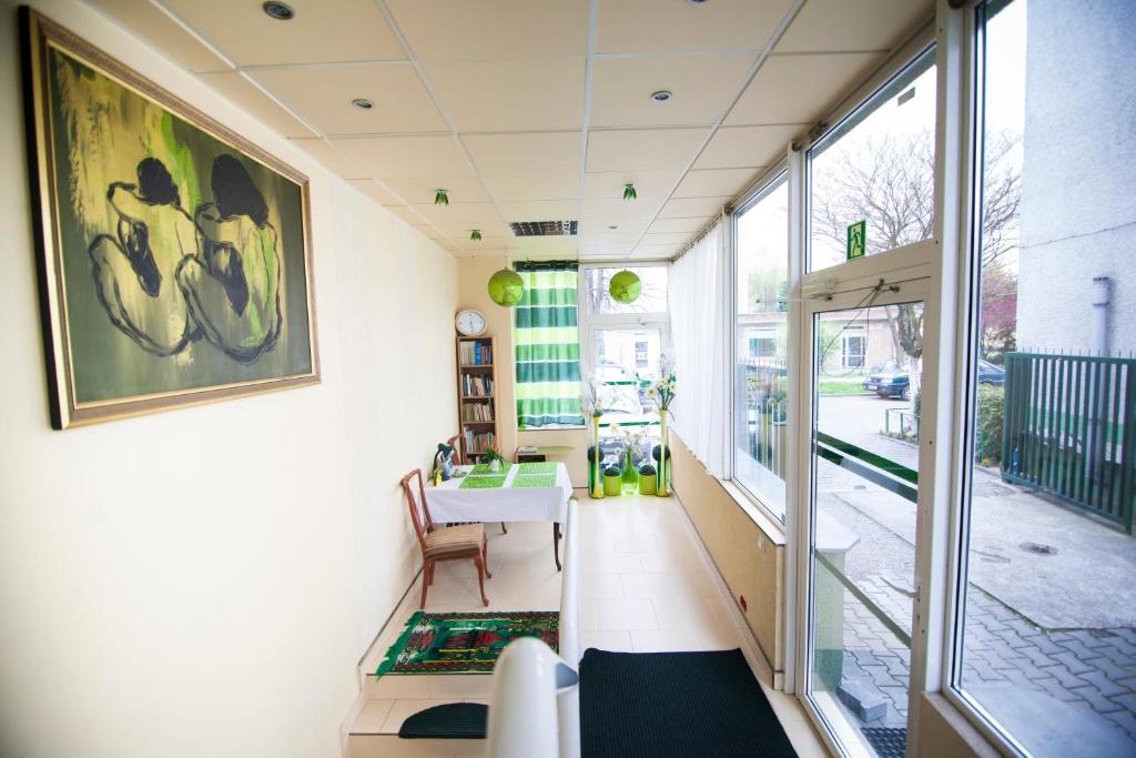 a room with a desk and a table and a window at Akacja Pokoje Gościnne in Kraków