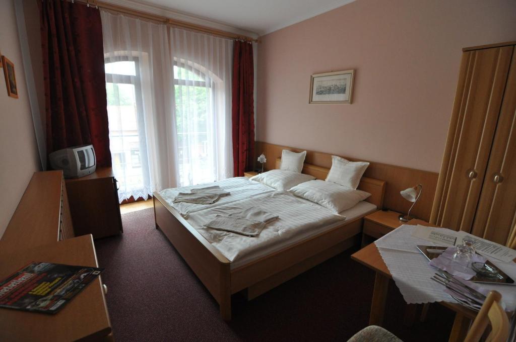 Postel nebo postele na pokoji v ubytování Hotel Átrium