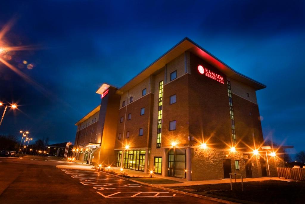 a hotel with a sign on the side of a building at Ramada Plaza Wrexham in Wrexham