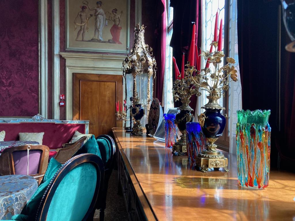 a room with a long table with vases on it at Palazzo Venart Luxury Hotel in Venice