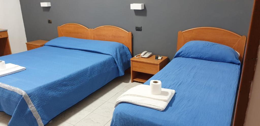 Postel nebo postele na pokoji v ubytování Hotel Milano
