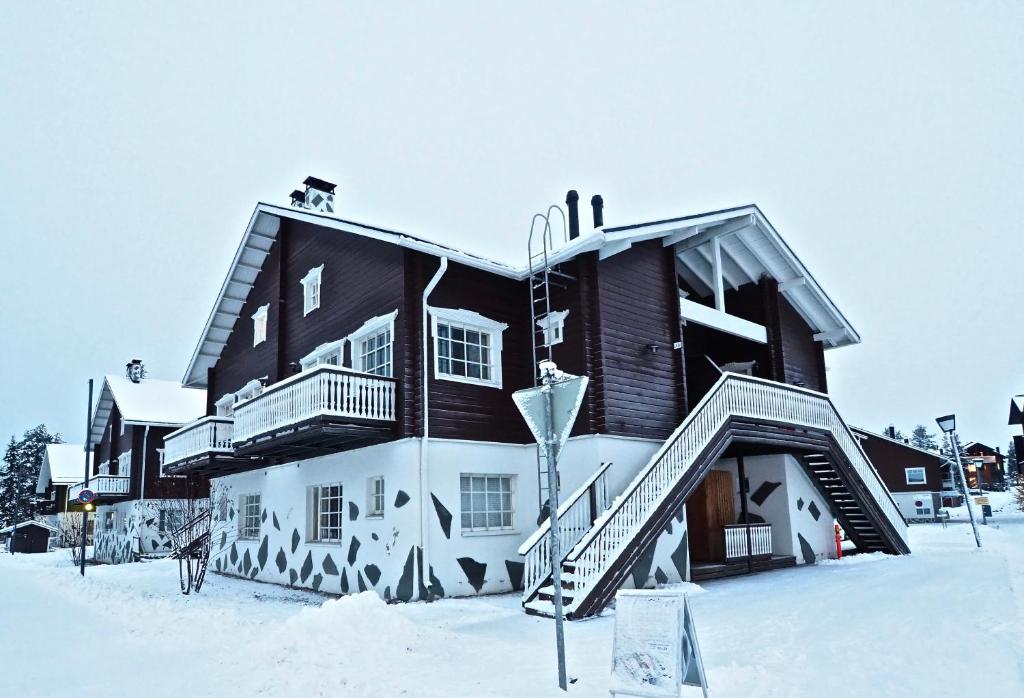 a large building with snow on the ground at Levin Keskusta, Levin Kalle A2 in Levi