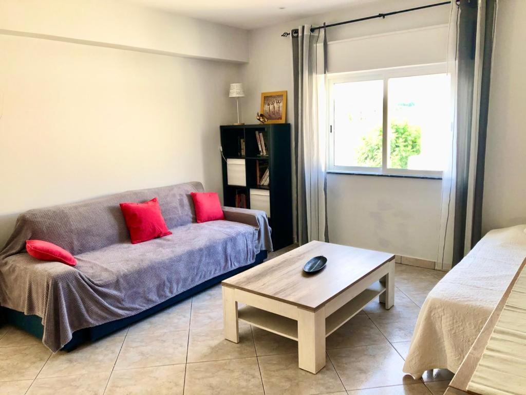 a living room with a couch and a coffee table at Appartement Tavira in Tavira
