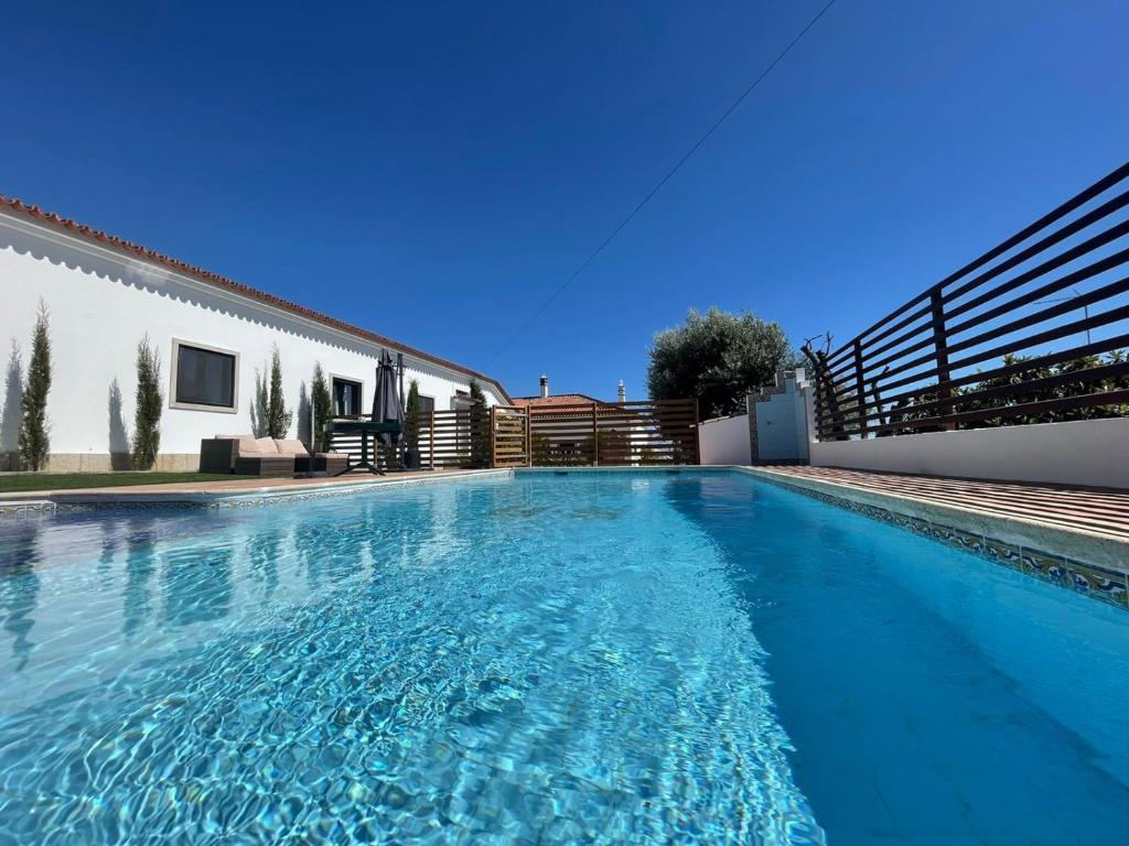 a swimming pool in front of a house at Casa Santo António in São Brás de Alportel