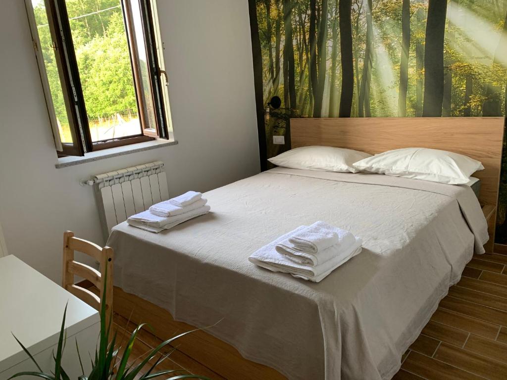 Postel nebo postele na pokoji v ubytování Ai Cerri di Remí