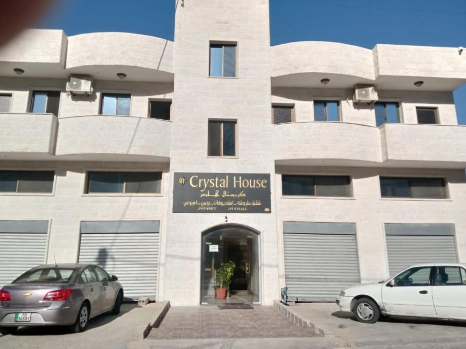 two cars parked in front of a building at Petra Crystal hotel in Wadi Musa