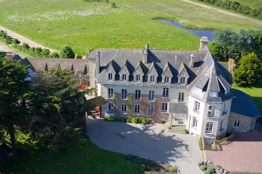 an aerial view of a large house with a turret at Château de Surville in Surville