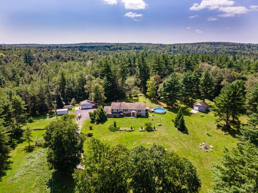 an aerial view of a house in the middle of a field at Southwoods Mountain Estate -private mansion, pool, hottub+ 15 acres in Monticello