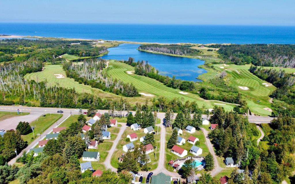 an aerial view of a golf course next to the ocean at Green Gables Bungalow Court in Cavendish