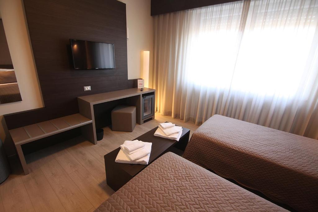 Postel nebo postele na pokoji v ubytování Hotel Santin