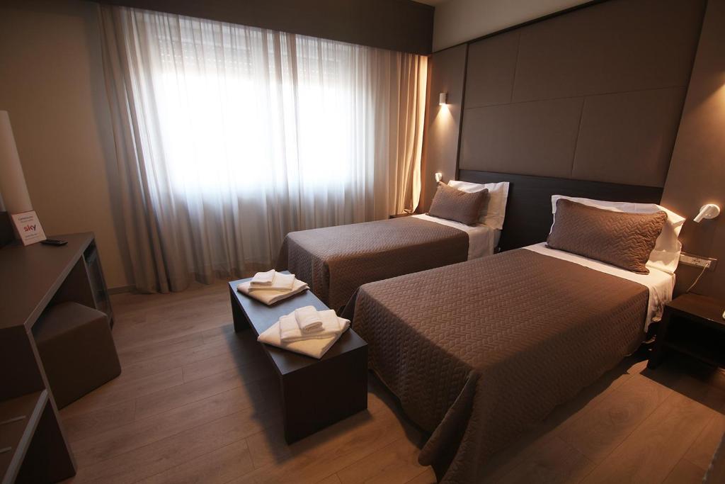 Postel nebo postele na pokoji v ubytování Hotel Santin