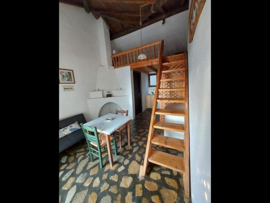 a room with a table and a bunk bed at Beautiful house located on a hill in Samos Island, 400 m from an organized beach in Koumeika