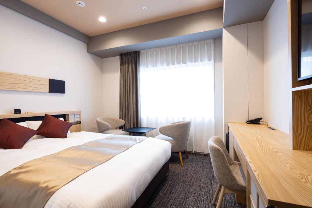 Postel nebo postele na pokoji v ubytování Hotel Grand Cocoe Kurashiki