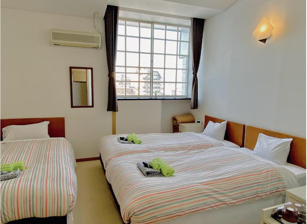 Postel nebo postele na pokoji v ubytování JAS HOTEL TAKAYAMA