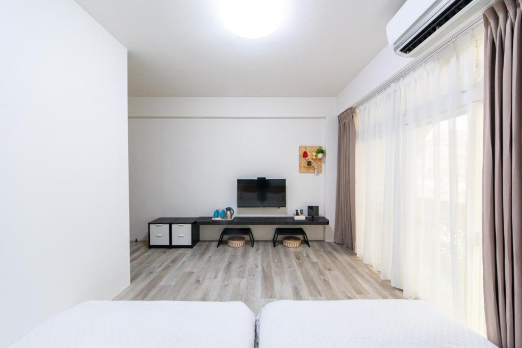 a living room with white furniture and a large window at 向晴民宿 花蓮市包棟民宿 in Hualien City