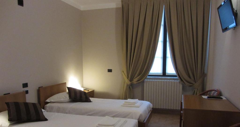 Postel nebo postele na pokoji v ubytování Villa Lomellini