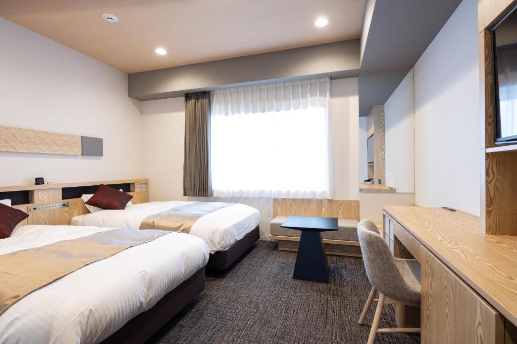 Postel nebo postele na pokoji v ubytování Hotel Grand Cocoe Kurashiki
