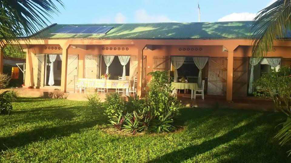 a house with a table in front of it at Maison du Bonheur in Sainte Marie