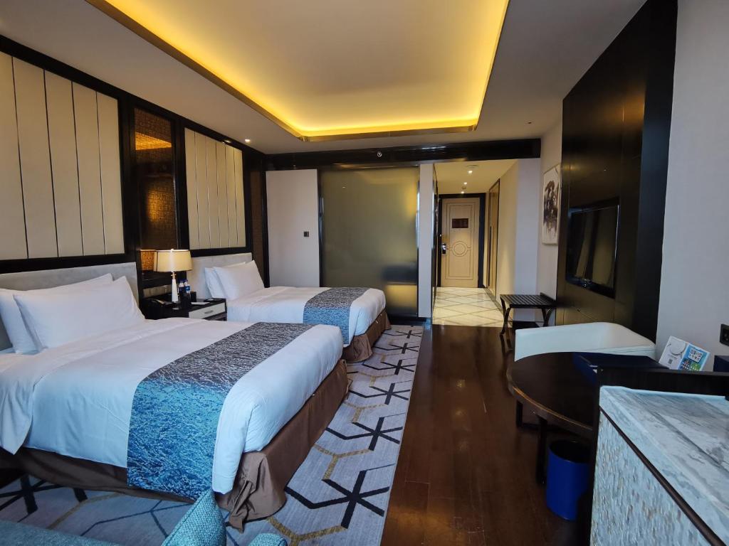 Postel nebo postele na pokoji v ubytování PRIMUS Hotel Wuhan Hannan