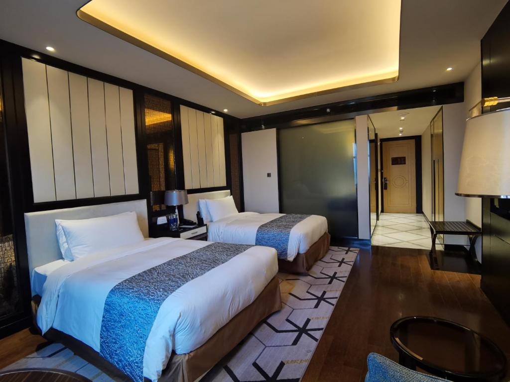 Postel nebo postele na pokoji v ubytování PRIMUS Hotel Wuhan Hannan
