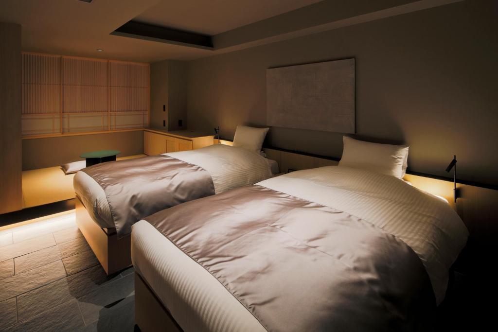 Postel nebo postele na pokoji v ubytování hotel tou nishinotoin kyoto