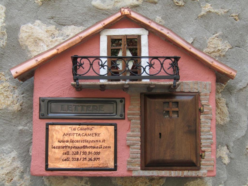 a house on the side of a building with a window at La Casetta in Penna in Teverina