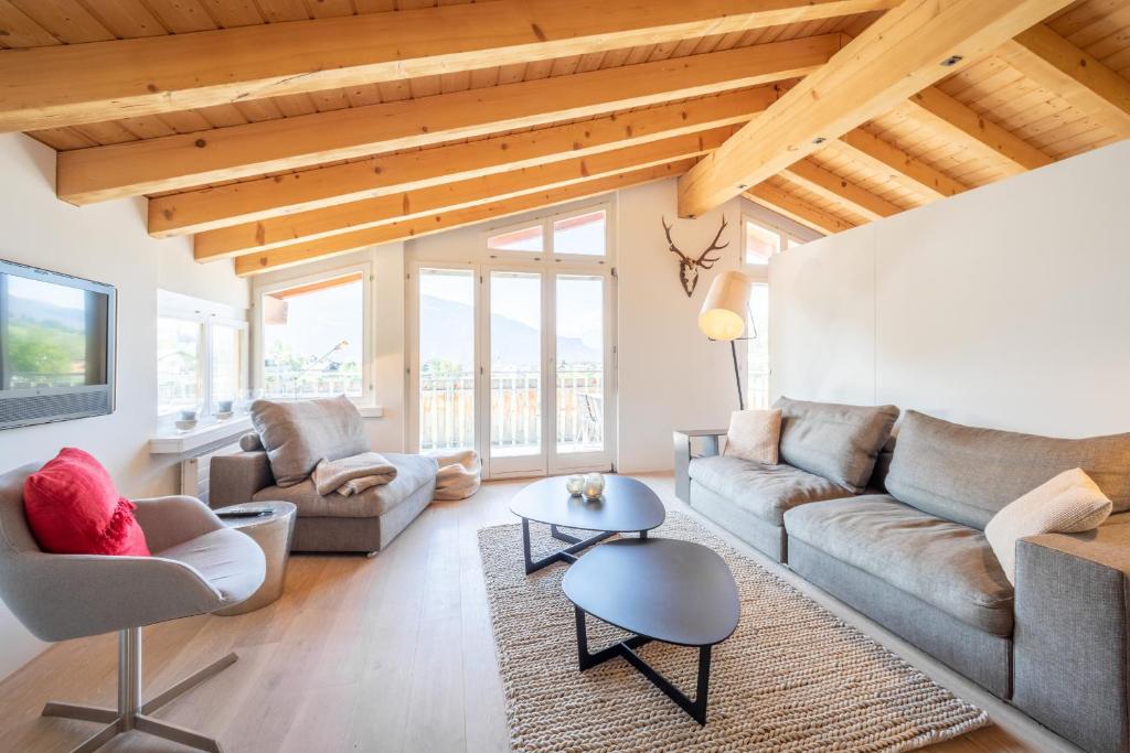 a living room with a couch and a table at COCOON - Laax in Laax
